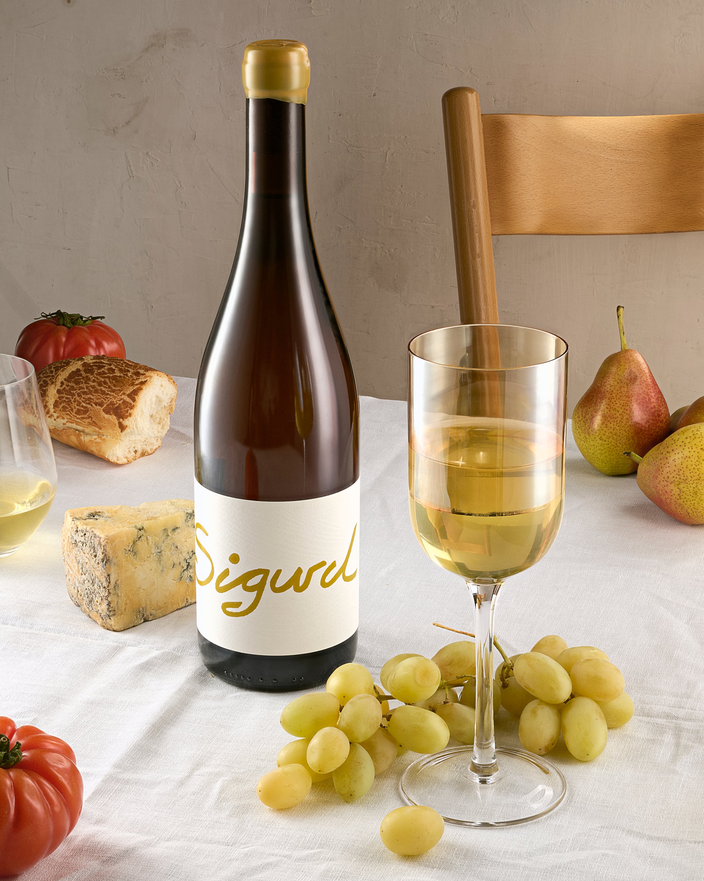 bottle of Sigurd Riesling with cheese and a glass of Riesling
